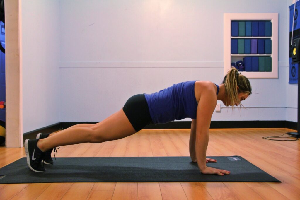 surf workouts. woman holding a plank pose.