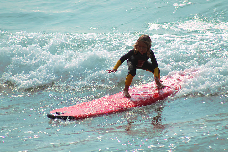 the surf experience. young surfer rides a wave in.